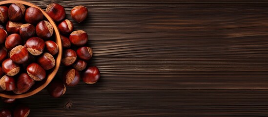 Aufkleber - Top view of a wooden table with a bowl of roasted sweet chestnuts There is ample space available for text in the image