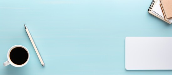 Aufkleber - A mockup photo of a working desk viewed from the top is displayed on a pastel blue background The desk features a tablet phone coffee cup and notebook with plenty of space for copy. Creative banner