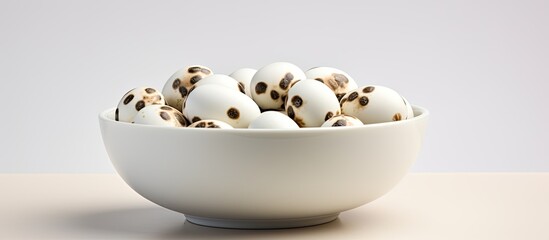 Poster - White bowl with quail eggs offering a perfect copy space image