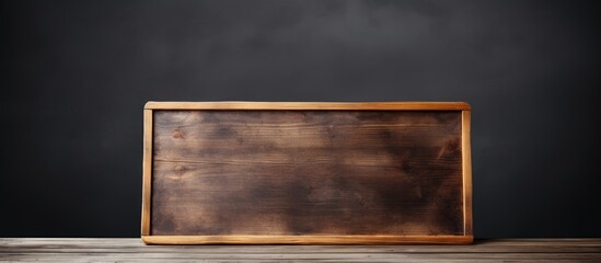Leinwandbilder - Wooden table with a blank chalkboard providing copy space for text and serving as a mock up for product display montages