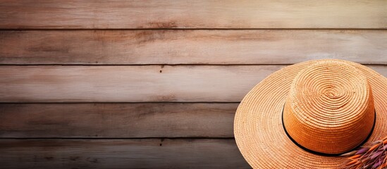 Poster - Wooden background with a beach hat providing copy space in the image
