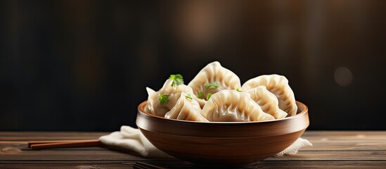 Aufkleber - A delicious bowl of dumplings sits on a wooden table with ample copy space for the image