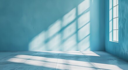 Poster - A minimalist image showing a spacious empty room with blue walls, sunlight casting shadows through a window creating patterns on the floor