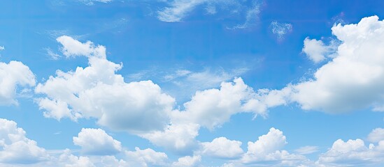 Fototapete - Sunny day with a clear blue sky adorned by white fluffy clouds offering ample copy space for images