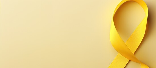 Poster - Top view of a yellow ribbon a symbolic image representing childhood cancer with ample copy space for text or graphics