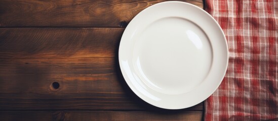 Poster - A vintage toned copy space image of a white plate resting on a napkin placed on a wooden tabletop against a grunge wall