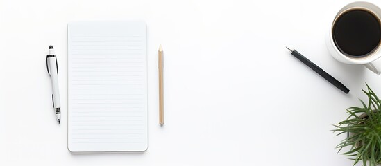 Fototapete - Top down view of a well equipped working space showcasing a notepad pen smart phone and cup of coffee neatly arranged over a white background This flat lay image offers ample copy space to relay your