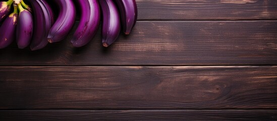 Aufkleber - Top view of a wooden table adorned with delicious purple bananas creating a visually appealing copy space image