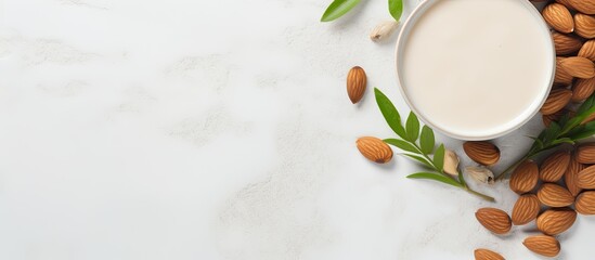 Aufkleber - Top view of a cup filled with almond milk surrounded by nuts and a potted plant placed on a white concrete background This non dairy and vegan composition creates a visually appealing copy space imag