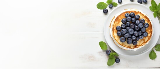 Wall Mural - Top view of a copy space image featuring light background with cottage cheese pancakes sour cream and blueberries Suitable for breakfast or lunch