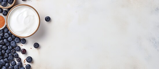 Poster - Top view of a copy space image featuring light background with cottage cheese pancakes sour cream and blueberries Suitable for breakfast or lunch