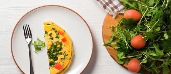Poster - A top view of a white plate with a breakfast spread includes an omelette filled with radish and green arugula accompanied by a salmon sandwich The frittata is a traditional Italian omelet The image h