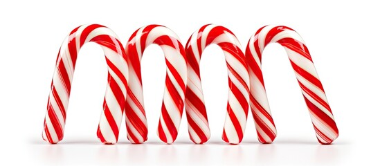 Aufkleber - A trio of candy canes specifically designed for Christmas decorations are shown separately on a white background with ample copy space for additional elements