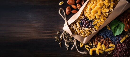 Aufkleber - A variety of colorful pasta is scattered on a white background inside a disposable brown kraft paper bag The image is captured from a top down perspective and there is ample empty space for text