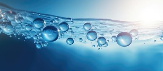 Poster - A vibrant macro abstract image showcases round bubbles of carbon dioxide floating in the translucent blue waters of the ocean providing ample copy space