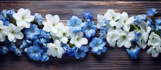 Aufkleber - A visually striking arrangement of blue and white flowers on a wooden background captured from an overhead perspective with empty space for additional content