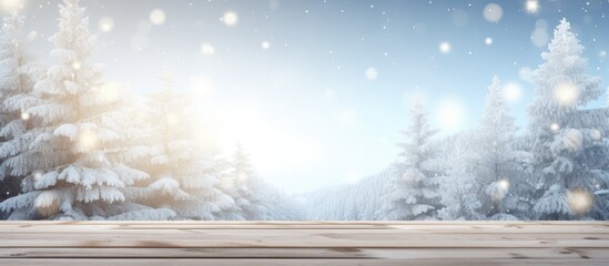 Poster - A wintry Christmas background featuring a snowy landscape with fir branches The wooden table is placed in the foreground with a blue tint and sunlight enhancing the image Plenty of copy space is avai