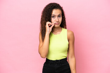 Wall Mural - Young hispanic woman isolated on pink background showing a sign of silence gesture