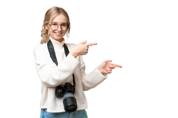 Sticker - Young photographer English woman over isolated background pointing finger to the side and presenting a product