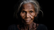 Portrait of elderly indigenous Australian woman with black background