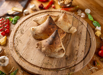 Wall Mural - Delicious calzones on a wooden board