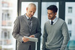 © peopleimages.com - Mature, man and young male for mentor, tablet and pointing in office for advice in business or workplace. Employee, intern and technology in meeting for brainstorming, ideas and plan in corporate