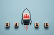 © Dilok - Red group of human icon inside rocket missile rising from black alone human icon for teamwork can improve productivity and job performance concept.