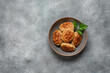 Fried homemade meat cutlets in a bowl on a gray concrete background. Top view, copy space.