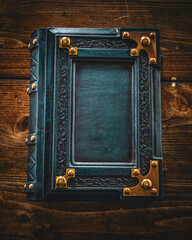 Wall Mural - Weathered blue leather book lay down to wooden table