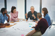 © peopleimages.com - Business people, architect and team in meeting with blueprint for building design, brainstorming and discussion. Architecture, employee and collaboration with floor plan in boardroom with diversity