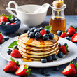 Stack of pancakes owith strawberry and blueberry