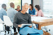 © peopleimages.com - Business people, teamwork and mature man with tablet in office for financial, review or investment check. Accounting, conversation and mentor with digital app for meeting, notes or schedule planning