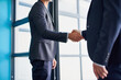 Business men, handshake and worker hands in office with agreement, deal or partnership. Greeting, welcome and onboarding at corporate company with professional contract and thank you at law firm