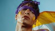 Close-up Portrait of a Young Man with Purple Headband and Yellow Face Paint Against a Blue Sky - Non-Binary person
