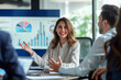 © Mikhail - Happy woman presenting financial results with graphs and charts at a meeting with business partners in an office room. Shallow depth of field
