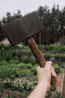 A strong man, a Scandinavian superhero, holds a hammer in his hands at work. Photography, mythology concept.