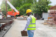 © JU.STOCKER - Foreman checking project at precast factory site, Engineer man in hardhats on construction site