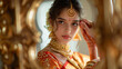 © INSPIRO SOURCE - Beautiful indian girl looking in mirror. Young hindu woman model with tatoo mehndi and gold jewelry. Traditional Indian costume..