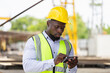 © JU.STOCKER - Engineer man in hardhats using mobile smartphone on construction site, Foreman worker at precast factory site
