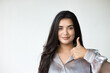 South Asian Woman giving approving thumb up for yes, alright, ok, positive, OK for all correct gesture