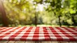 © Generative AI - Red checked tablecloth on wood with blur green courtyard backgroundSummer and picnic conceptsDesign for key visual food and drink productsno people : Generative AI
