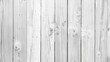 The image is a white wooden fence with vertical planks