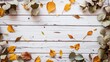 The image shows a whitewashed wooden background with a border of eucalyptus leaves and scattered autumn leaves in warm colors.