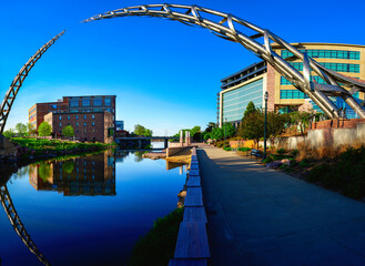 Wall Mural - Sioux Falls Downtown River Greenway Trail, Skyline, Bridges, and Reflectoins on the Big Sioux River Water at Dusk in South Dakota, USA