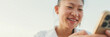 © Andrii Nekrasov - Closeup, Smiling young woman using mobile phone on seascape background, Panorama