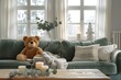 A cute teddy bear sitting on the green sofa in an elegant living room
