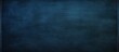 © StockKing - A dark blue chalkboard with traces of erasing featuring a full surface frame and a textured background Copy space image