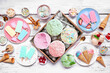 Cool summer food table scene. Assorted ice cream, popsicles and frozen treats. Pastel colors. Top view on a white wood background.