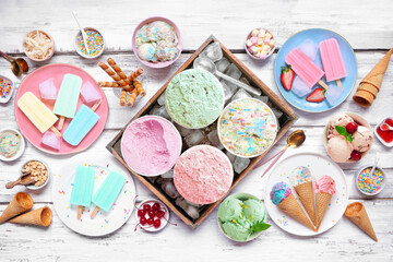 Poster - Cool summer food table scene. Assorted ice cream, popsicles and frozen treats. Pastel colors. Top view on a white wood background.