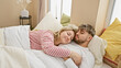 © Krakenimages.com - Affectionate couple sleeping together in a cozy bedroom setting, embodying love and intimacy in a domestic environment